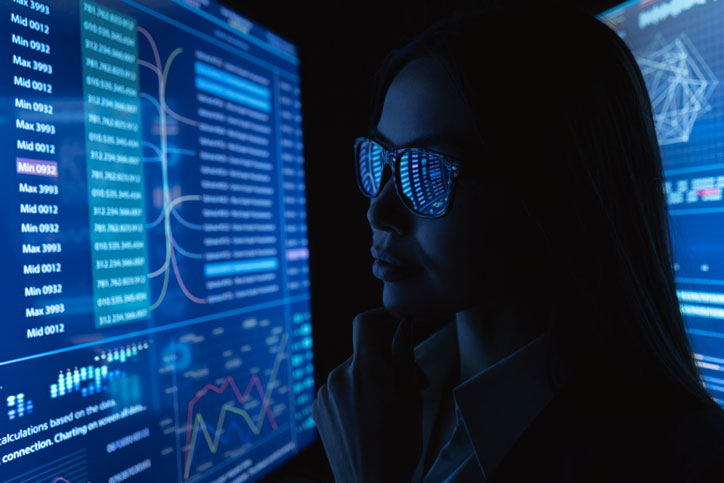 data scientist looking at monitors