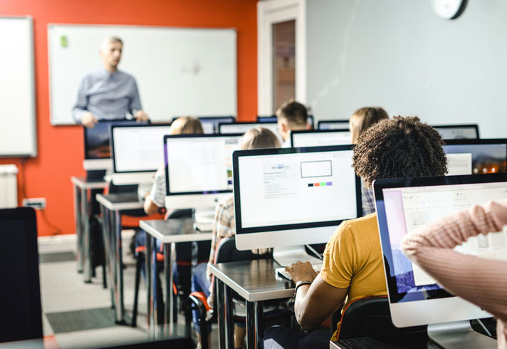 full classroom of computers and students